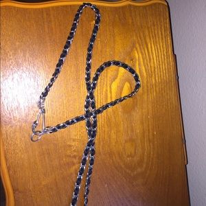 Long silver chain necklace with ribbon.